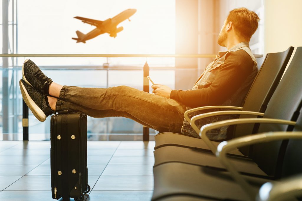 man waiting to be informed in an airport