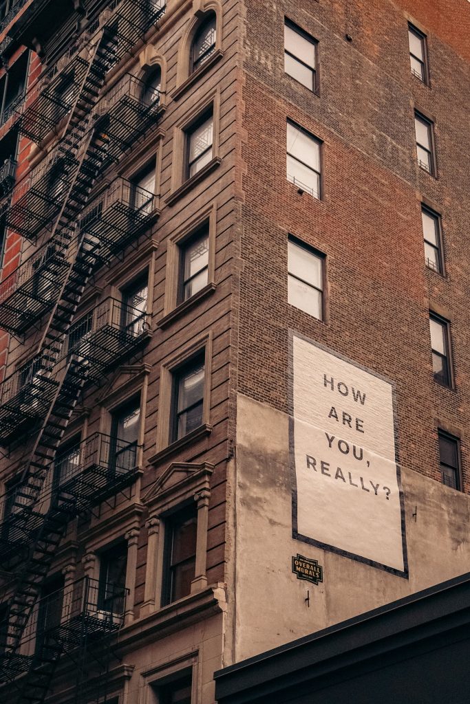 a building with massive billboard 'tell me what you feel'