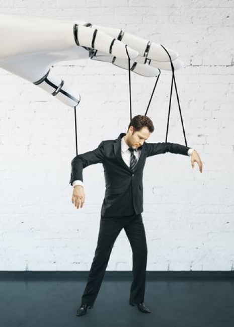 Robotic hand manipulating businessman on brick background. Future concept